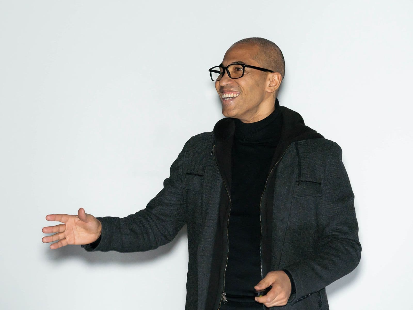 Salime Nassur smiling mid-speech, on a white background